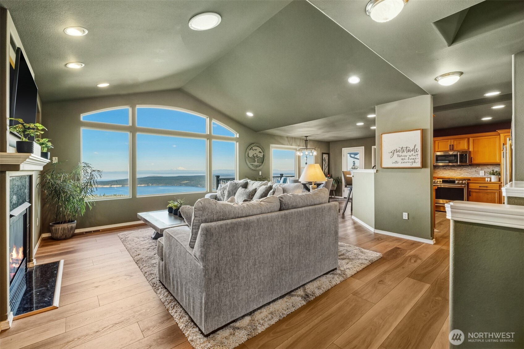 855 Louella Heights Road Sequim, WA 98382 - Photo 6 of 40 a living room with furniture a floor to ceiling window and wooden floor