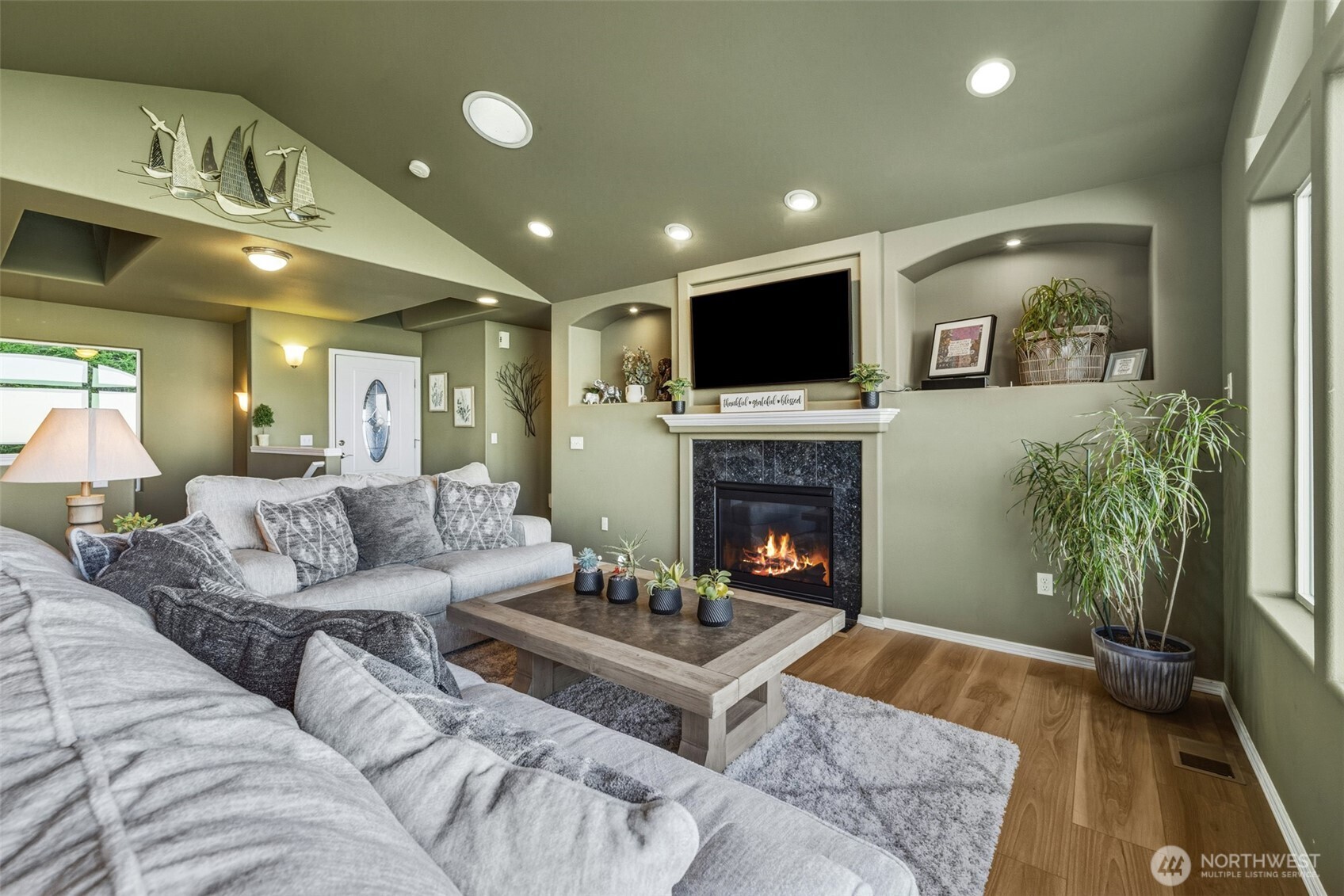 855 Louella Heights Road Sequim, WA 98382 - Photo 9 of 40 a living room with furniture a flat screen tv and a fireplace