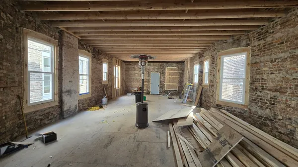 a lobby with furniture and floor to ceiling window