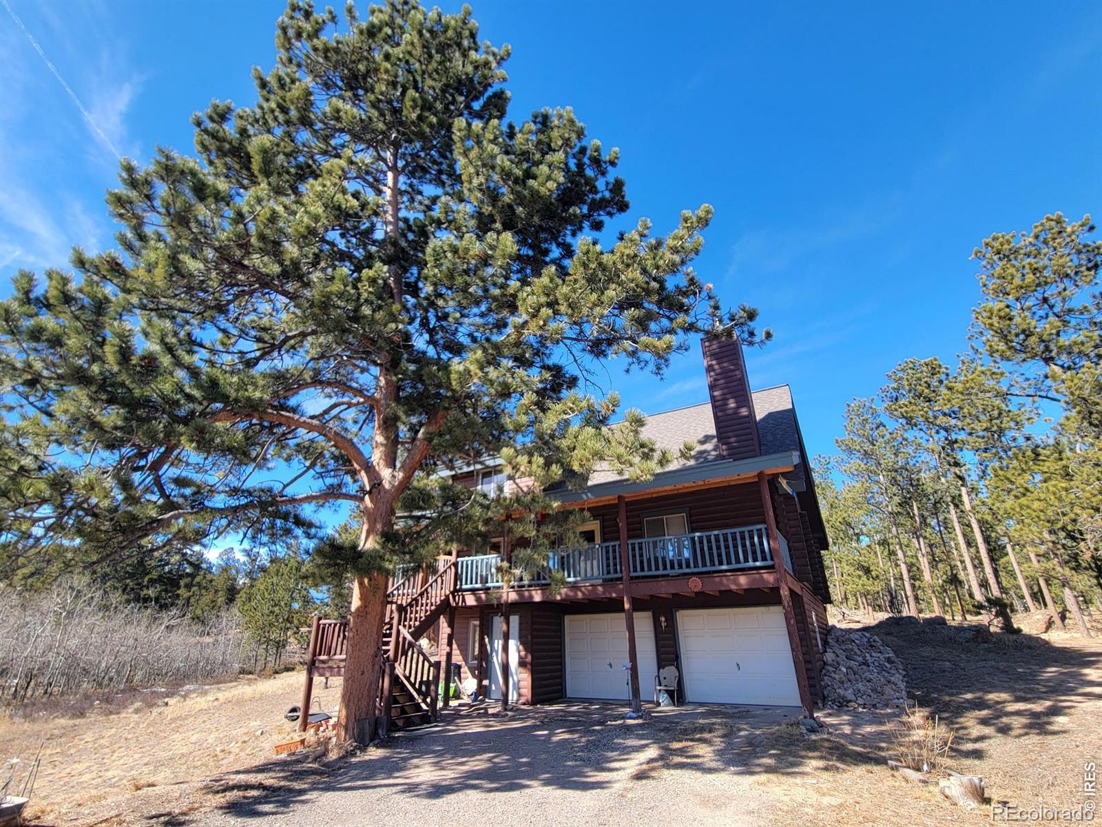 2225 North County Road Red Feather Lakes, CO 80545 - Photo 1 of 21 a view of a house with a tree