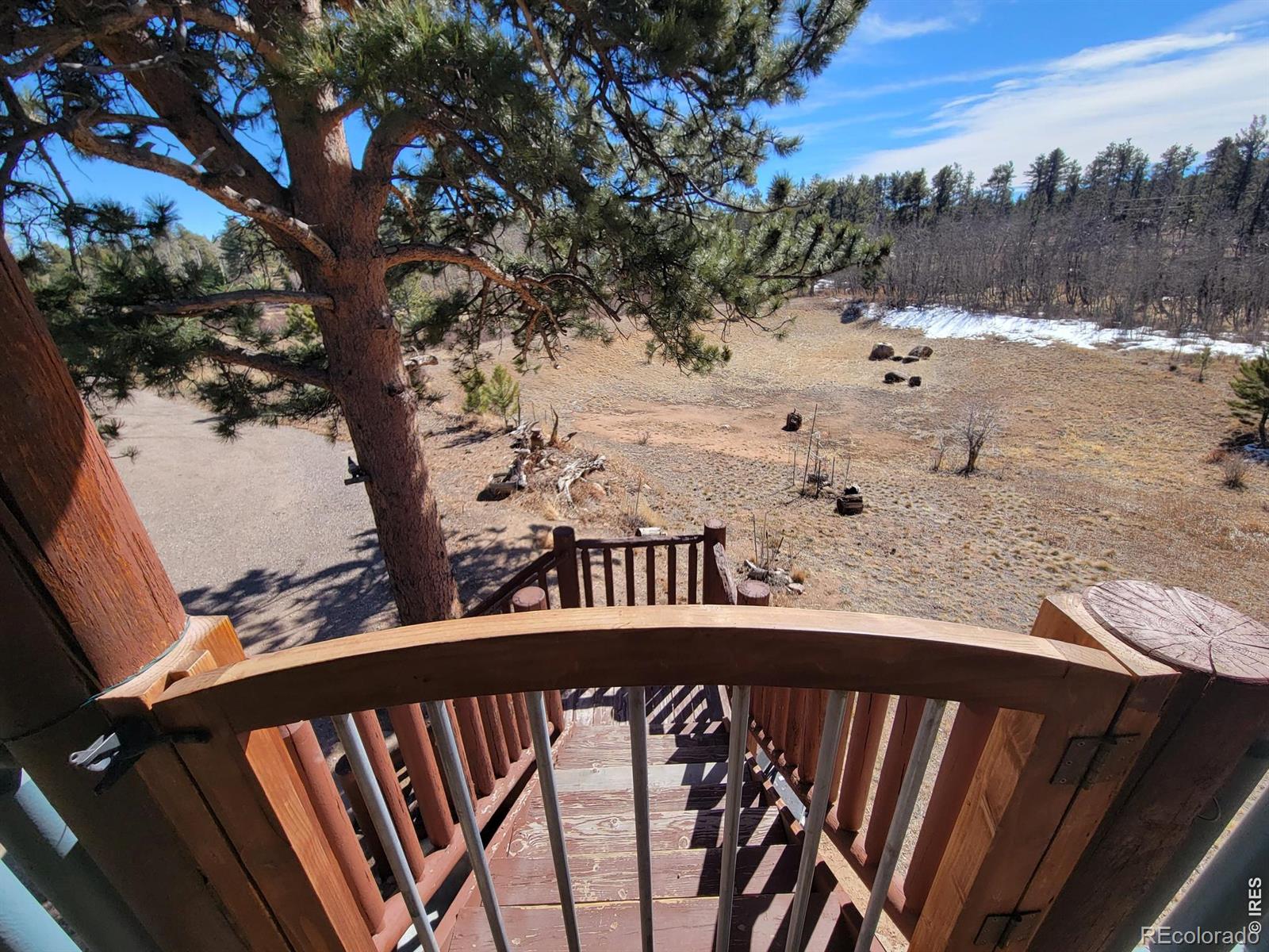 2225 North County Road Red Feather Lakes, CO 80545 - Photo 5 of 21 a view of a balcony with wooden fence