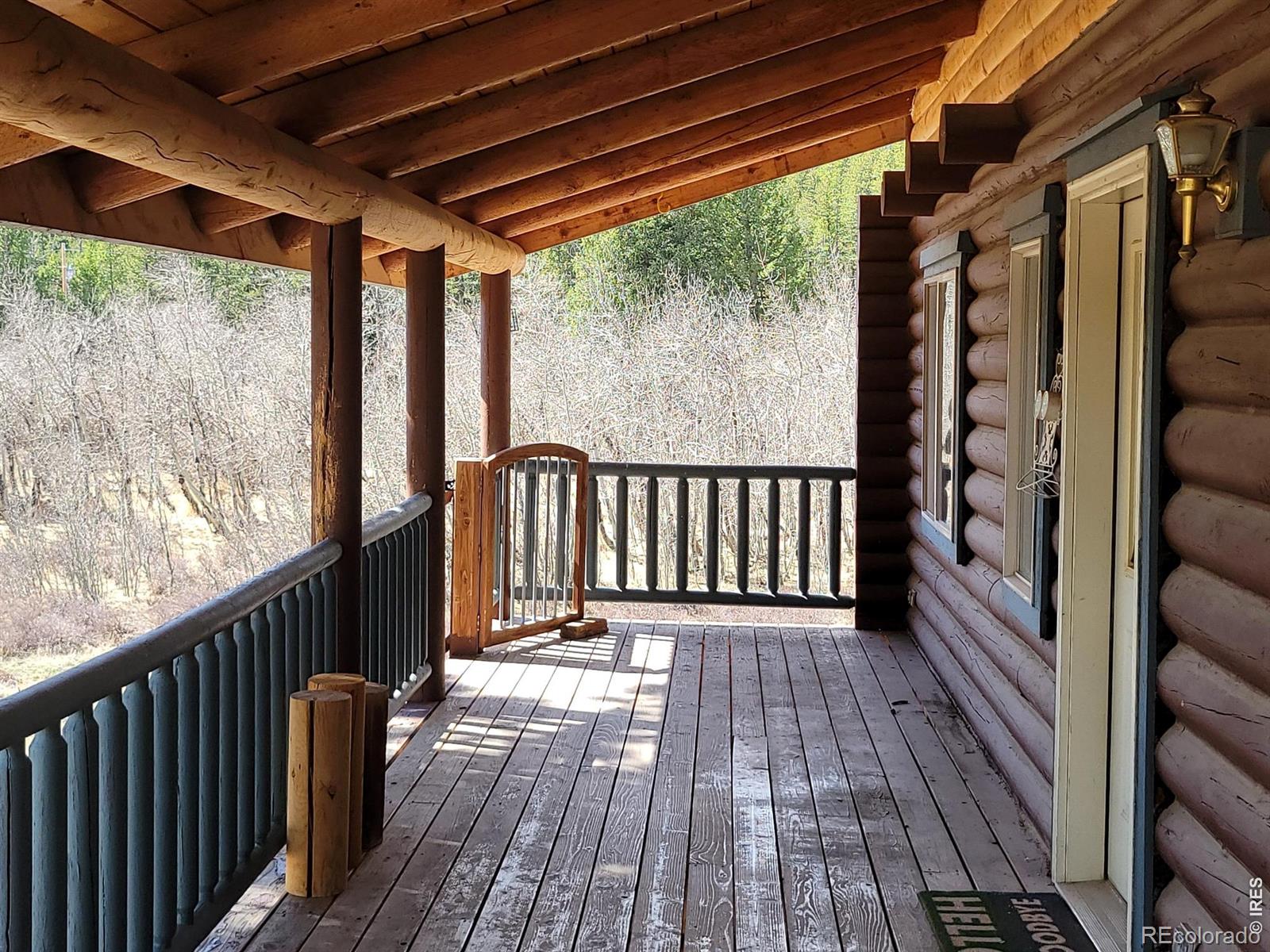 2225 North County Road Red Feather Lakes, CO 80545 - Photo 6 of 21 a view of a balcony with wooden floor