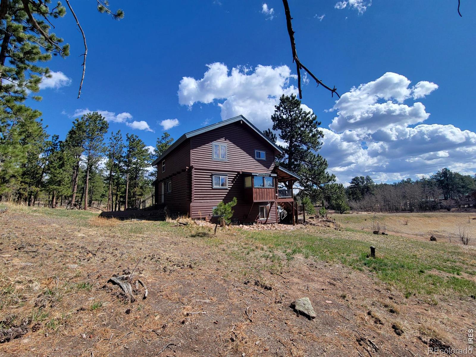 2225 North County Road Red Feather Lakes, CO 80545 - Photo 7 of 21 a view of a house with a yard
