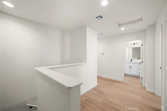 a view of an empty room and wooden floor