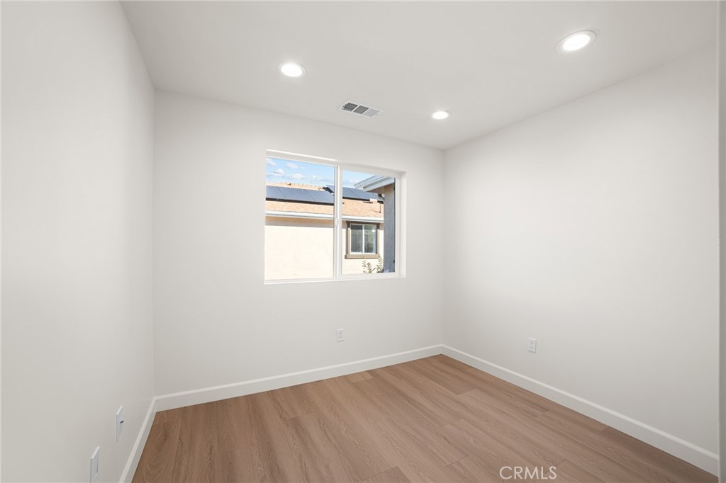 306 West Congress Street Colton, CA 92324 - Photo 14 of 28 an empty room with wooden floor and windows