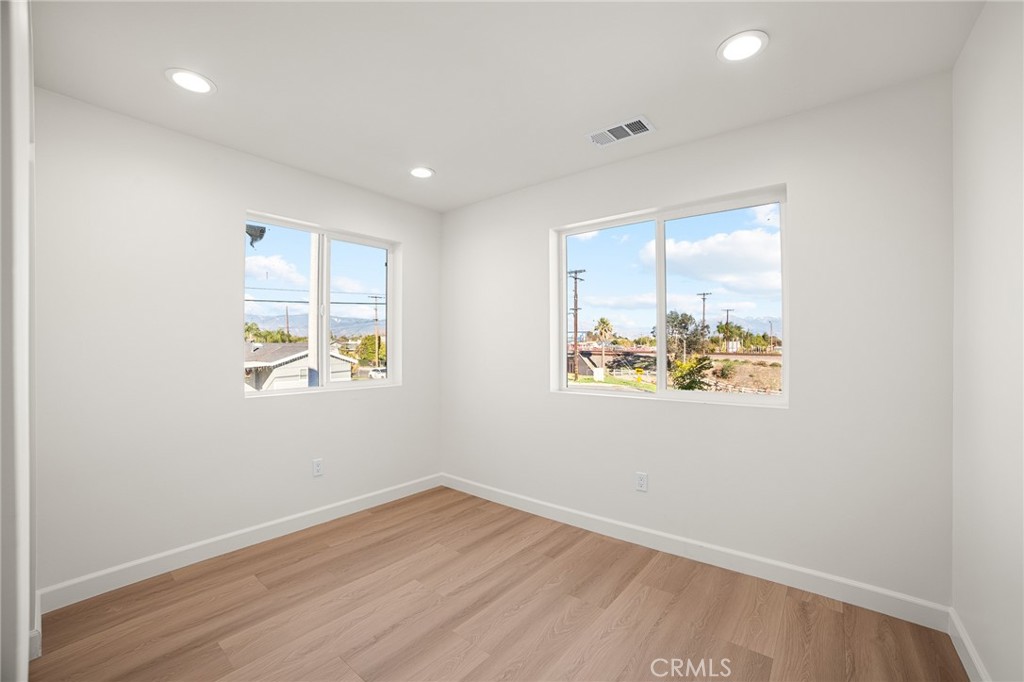 306 West Congress Street Colton, CA 92324 - Photo 15 of 28 an empty room with wooden floor and windows