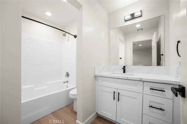 a bathroom with a bathtub a sink a vanity and a mirror