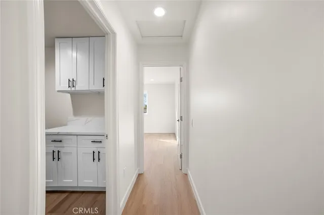 a view of hallway with wooden floor