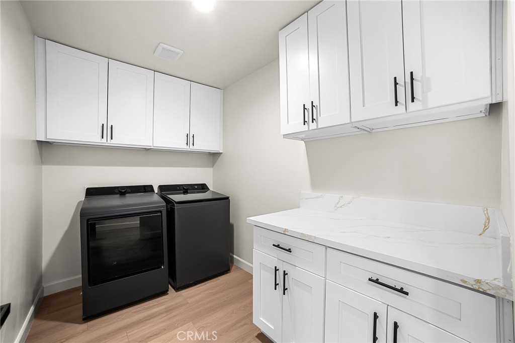 306 West Congress Street Colton, CA 92324 - Photo 18 of 28 a kitchen with white cabinets and appliances