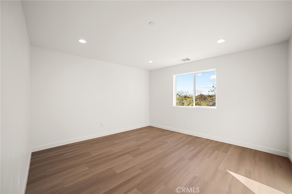 306 West Congress Street Colton, CA 92324 - Photo 19 of 28 an empty room with wooden floor and window