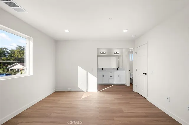 a view of empty room with wooden floor