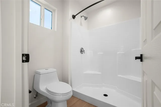 a bathroom with a shower and a toilet