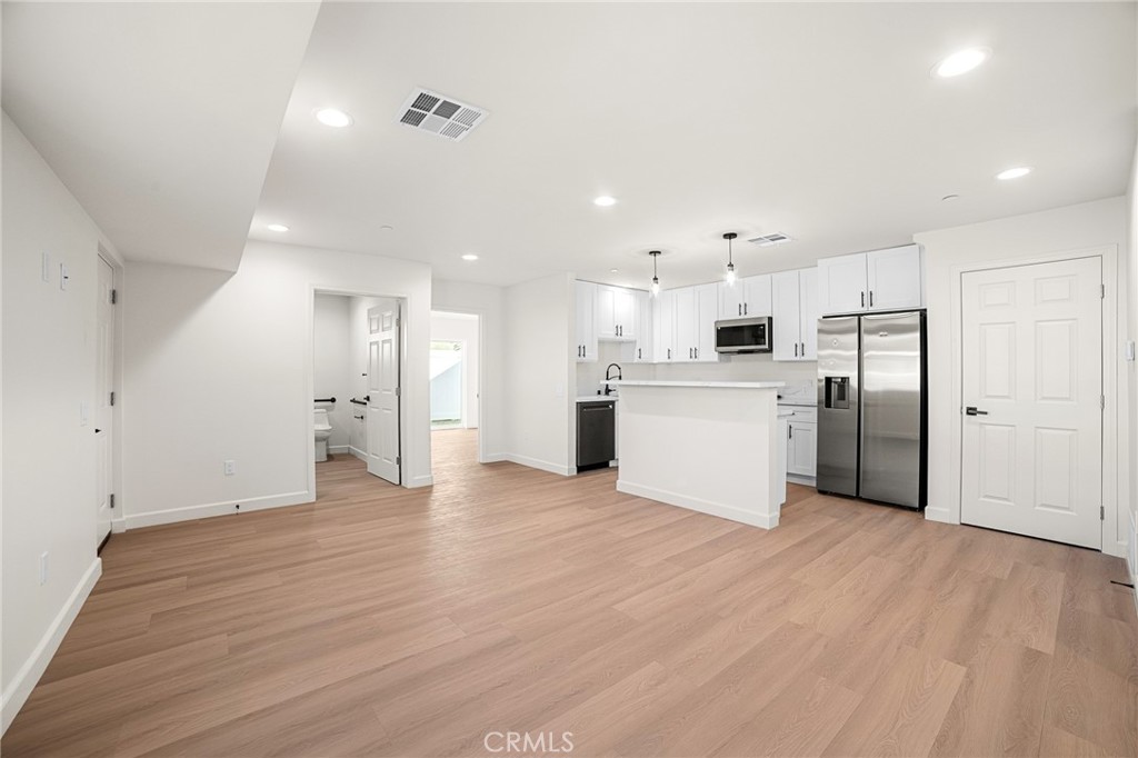 306 West Congress Street Colton, CA 92324 - Photo 4 of 28 a view of a kitchen with a refrigerator and a microwave