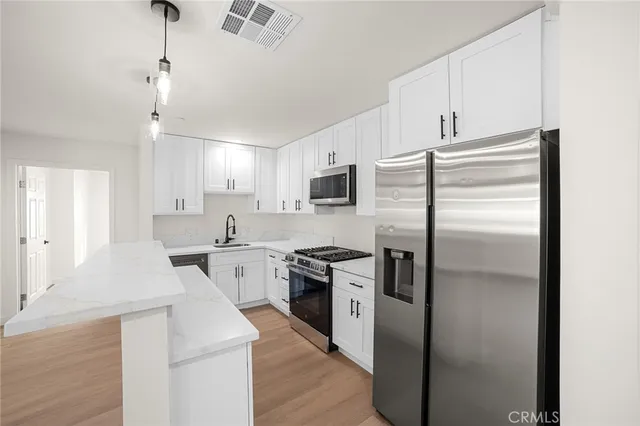 a kitchen with a refrigerator stove and sink