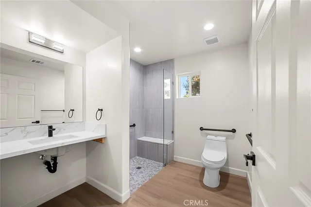 a bathroom with a sink toilet and shower