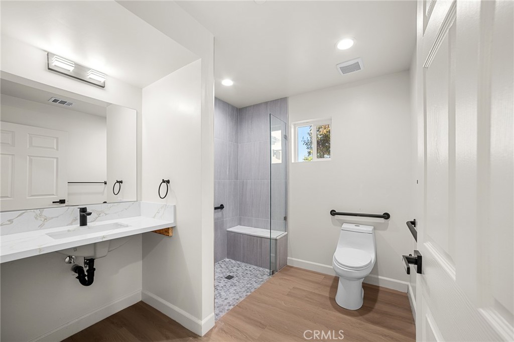 306 West Congress Street Colton, CA 92324 - Photo 10 of 28 a bathroom with a sink toilet and shower