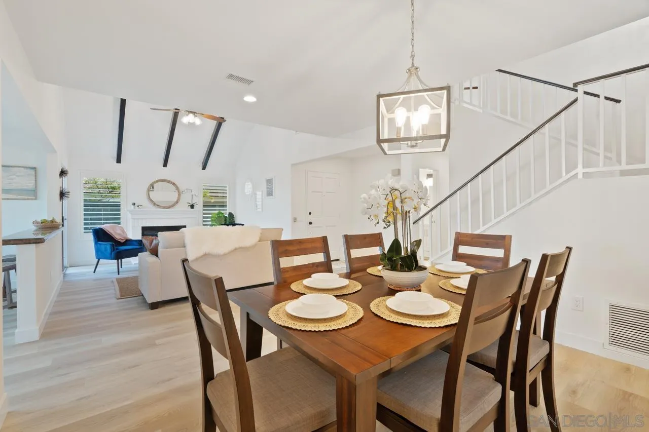 1904 Willow Ridge Drive Vista, CA 92081 - Photo 18 of 70 a view of a dining room with furniture a chandelier and wooden floor