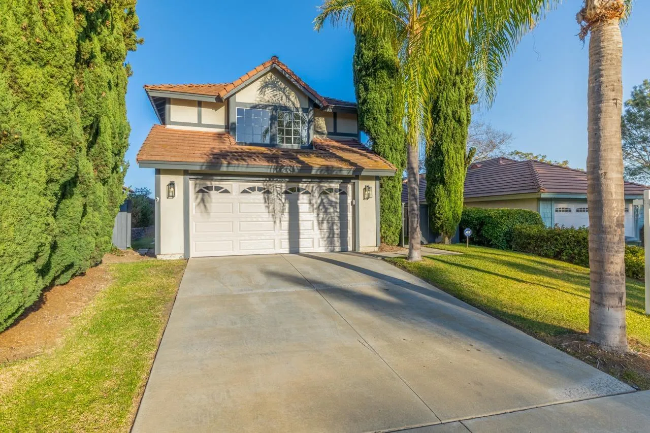 1904 Willow Ridge Drive Vista, CA 92081 - Photo 3 of 70 a front view of a house with a yard and garage