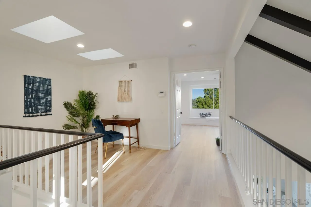 1904 Willow Ridge Drive Vista, CA 92081 - Photo 35 of 70 a view of a hallway to a livingroom with wooden floor and furniture