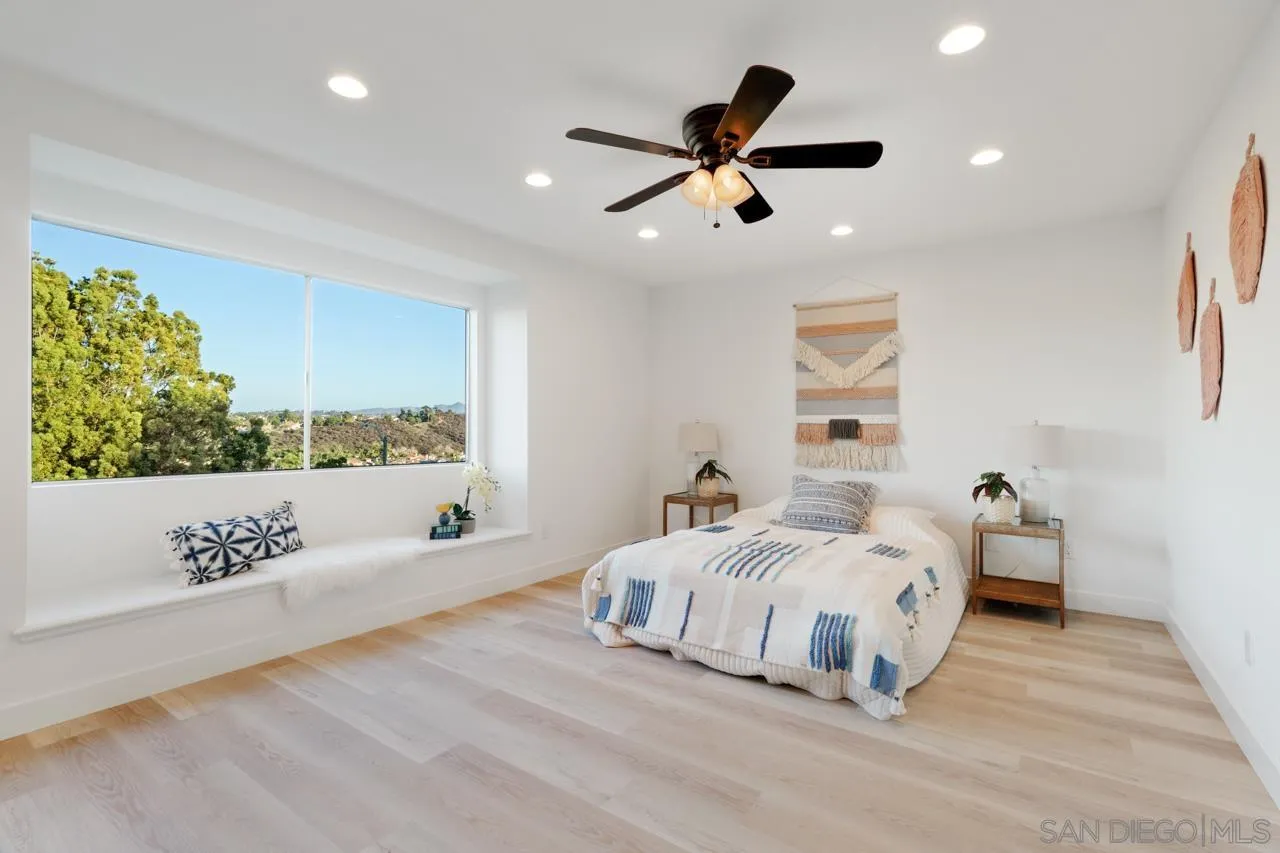 1904 Willow Ridge Drive Vista, CA 92081 - Photo 40 of 70 a bedroom with a large bed chandelier and a window