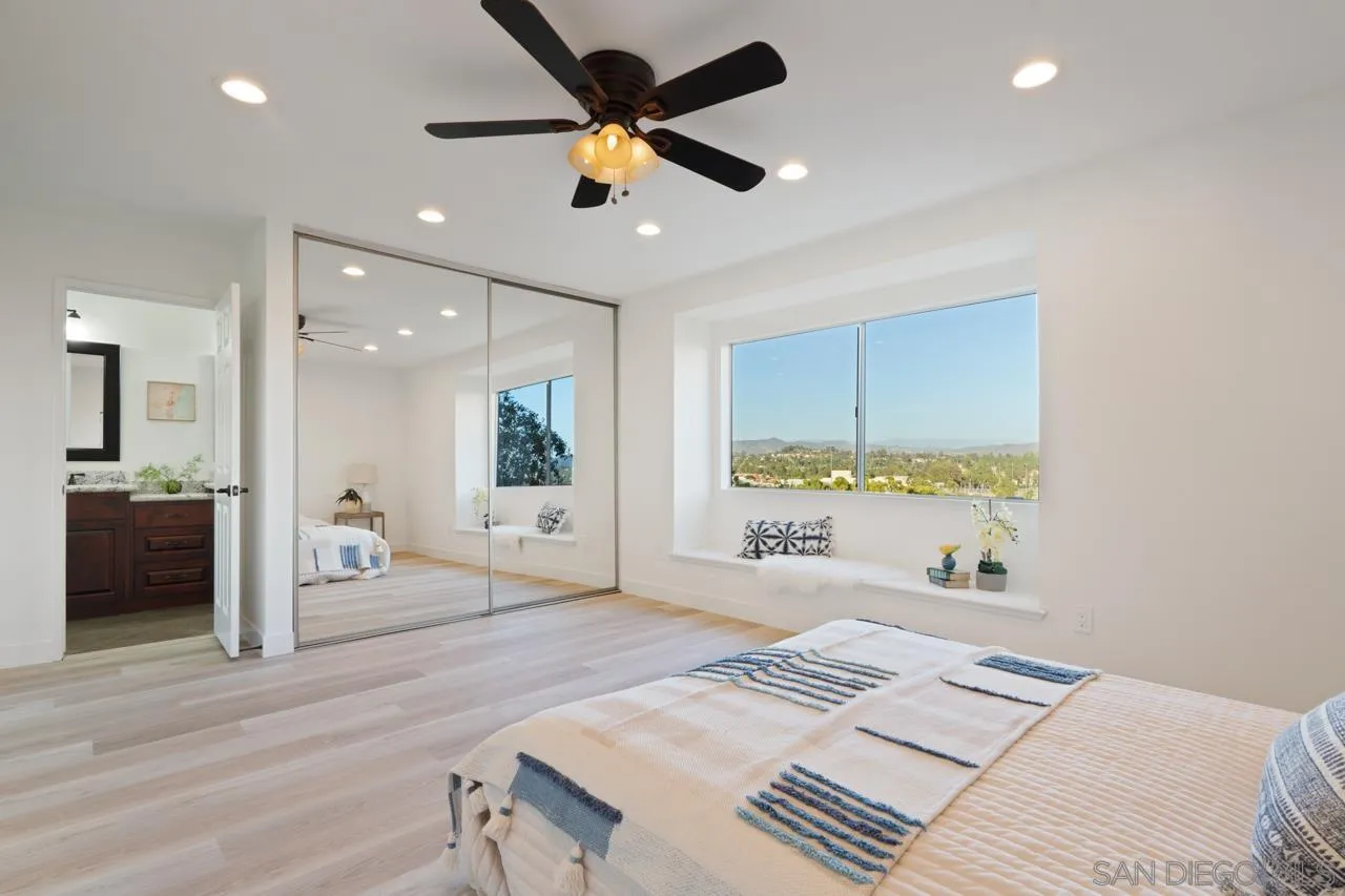 1904 Willow Ridge Drive Vista, CA 92081 - Photo 43 of 70 a bedroom with a bed and a walk in closet with wooden floor
