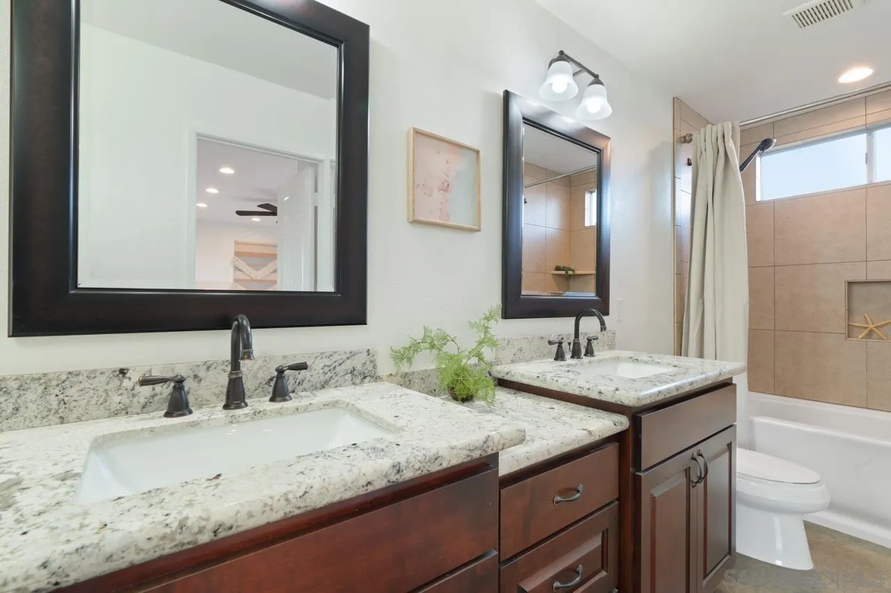 1904 Willow Ridge Drive Vista, CA 92081 - Photo 45 of 70 a bathroom with a granite countertop double vanity sink and a mirror