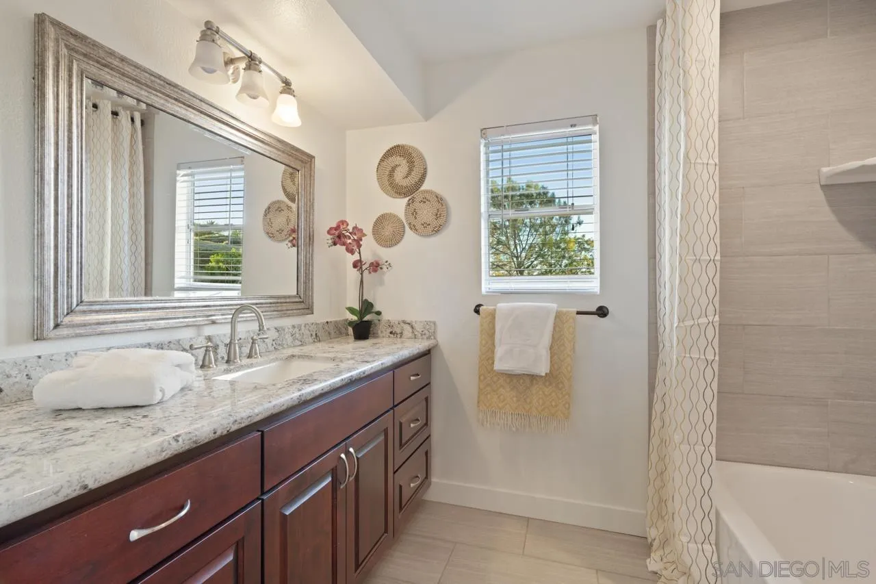1904 Willow Ridge Drive Vista, CA 92081 - Photo 50 of 70 a bathroom with a granite countertop sink and a mirror