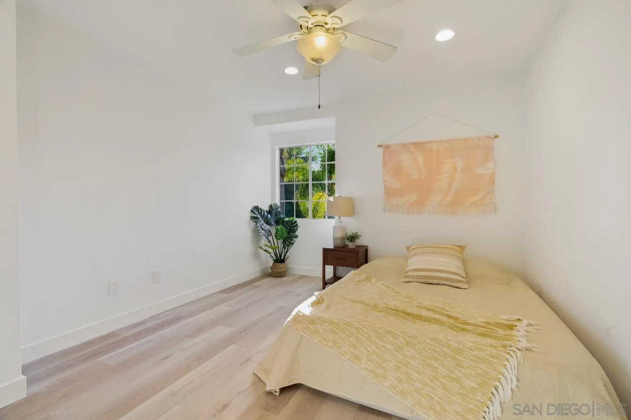 1904 Willow Ridge Drive Vista, CA 92081 - Photo 54 of 70 a bedroom with a bed and a chandelier