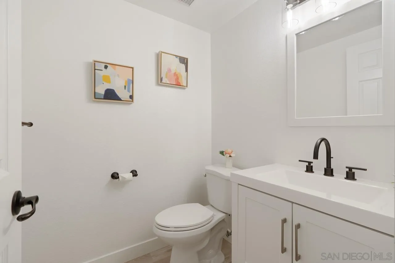 1904 Willow Ridge Drive Vista, CA 92081 - Photo 55 of 70 a bathroom with a sink mirror and toilet