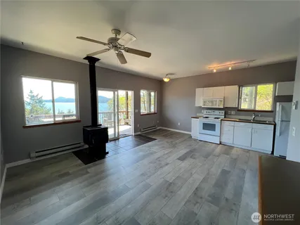 a view of kitchen with sink microwave and refrigerator