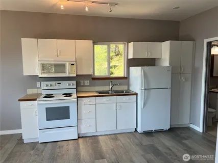a kitchen with a white cabinets and white appliances