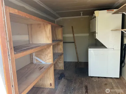 a view of walk in closet with wooden floor