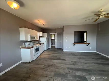 a large kitchen with kitchen island granite countertop a stove and a sink