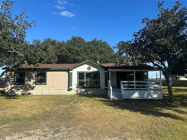 a front view of a house with yard and seating area