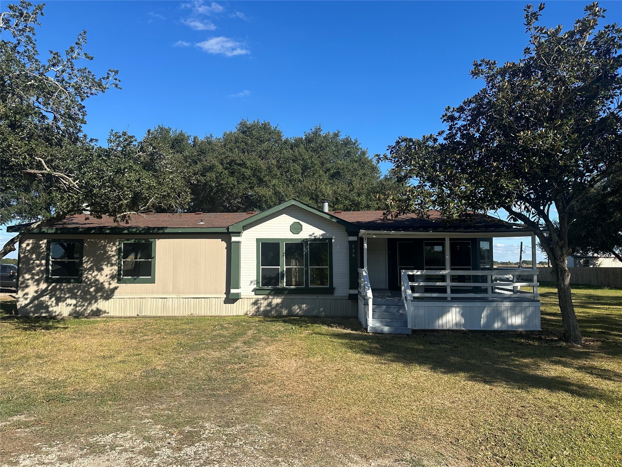 a front view of a house with yard and seating area