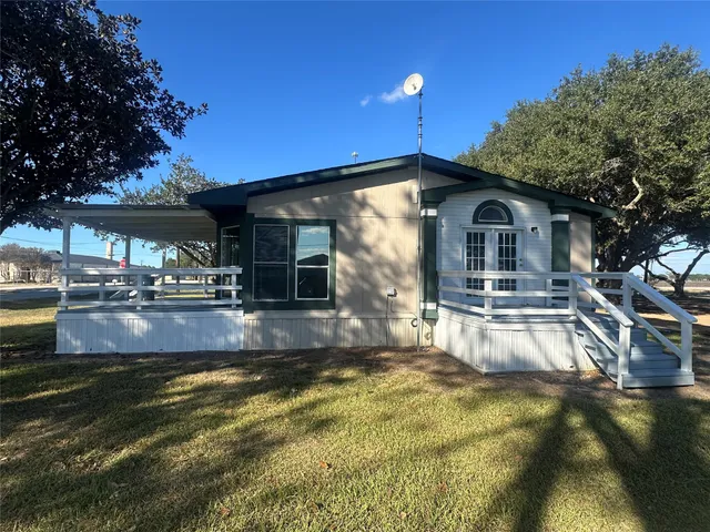 a view of a house with pool and a yard