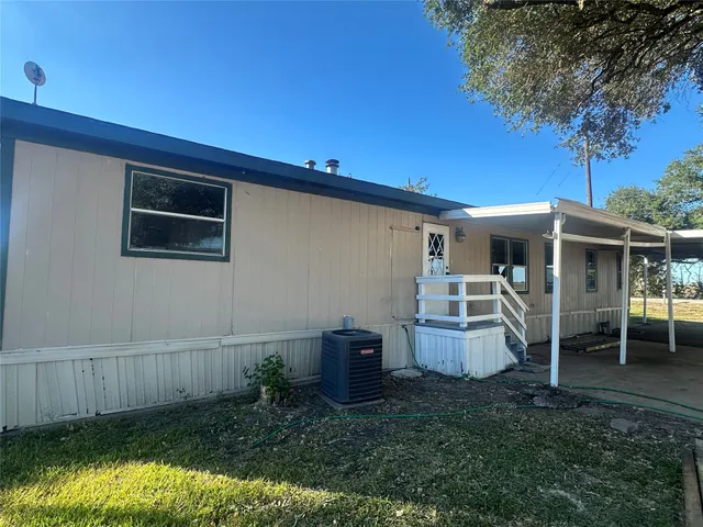 a backyard of a house with barbeque oven fire pit table and chairs
