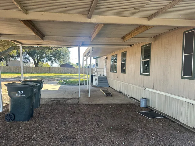 a view of a patio with table and chairs