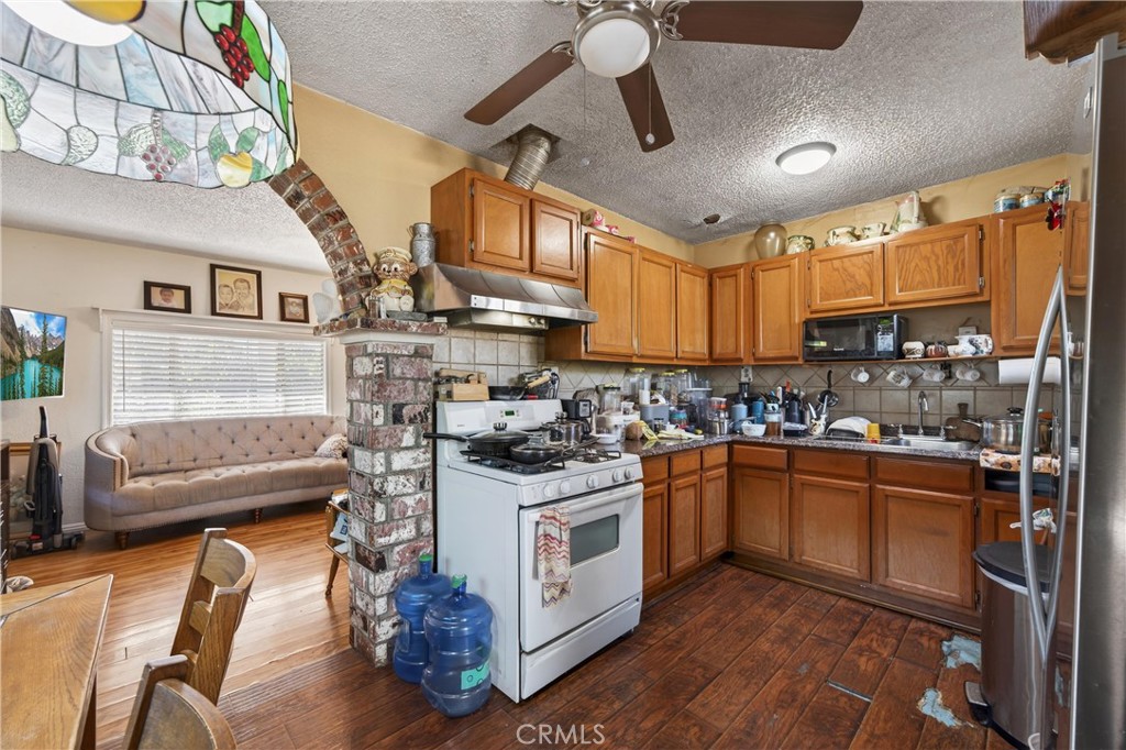 2437 Bloomdale Street Duarte, CA 91010 - Photo 14 of 23 a kitchen with stainless steel appliances granite countertop a sink a stove and a refrigerator