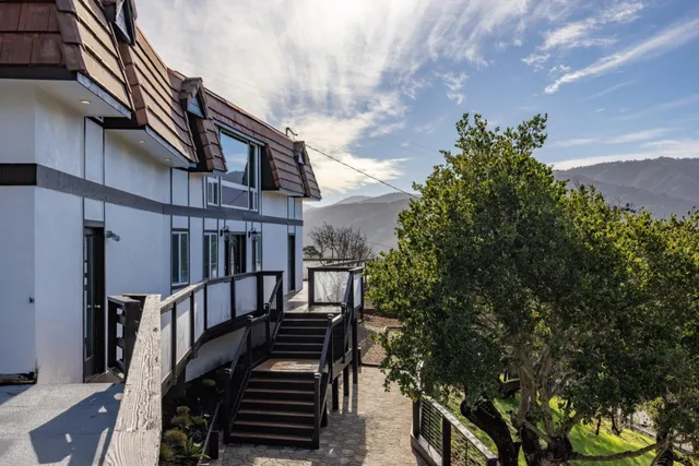 a view of a house with street and trees
