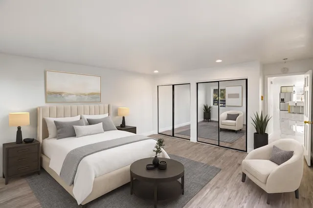 a bedroom with furniture and a potted plant