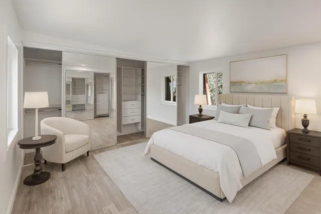 a spacious bedroom with a bed and a couch