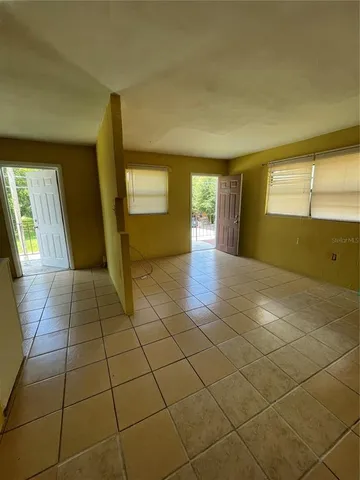 a view of a livingroom with wooden floor and a window