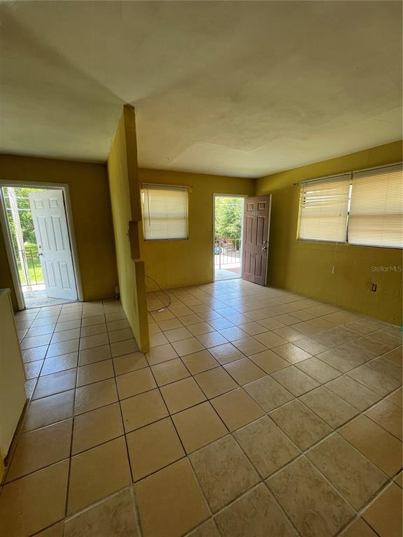 900 Colyer Street, Unit 902 Orlando, FL 32805 - Photo 2 of 7 a view of a livingroom with wooden floor and a window