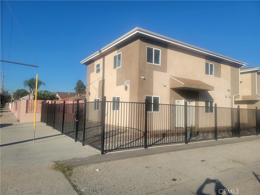 a front view of a house with wooden fence