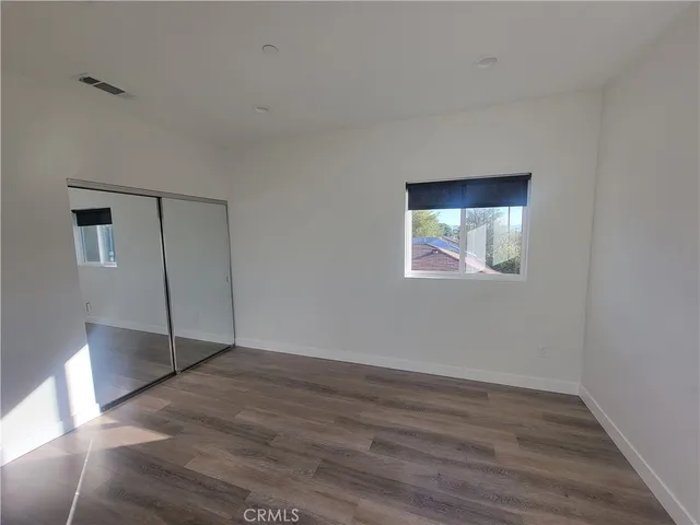 a view of a room with wooden floor