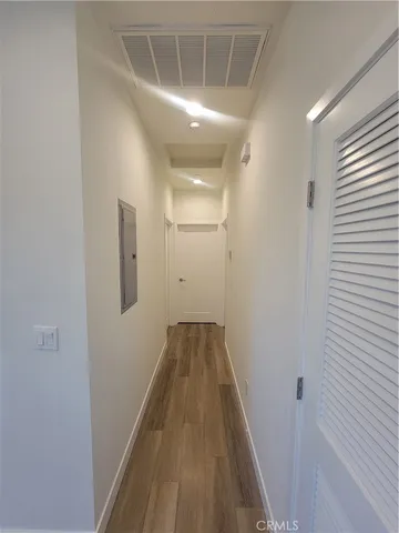 an empty room with wooden floor and a window