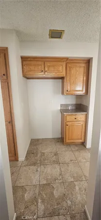 a view of a kitchen with a sink a stove and cabinets