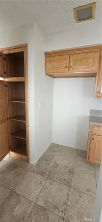a view of storage and utility room with closet