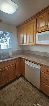 a kitchen with granite countertop a sink and cabinets